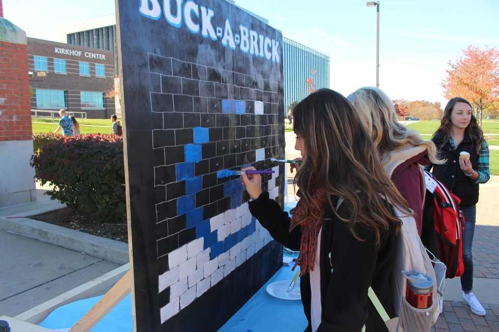Student paints brick
